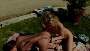 Lesbian blonde and Asian girls with big tits play with toys in park